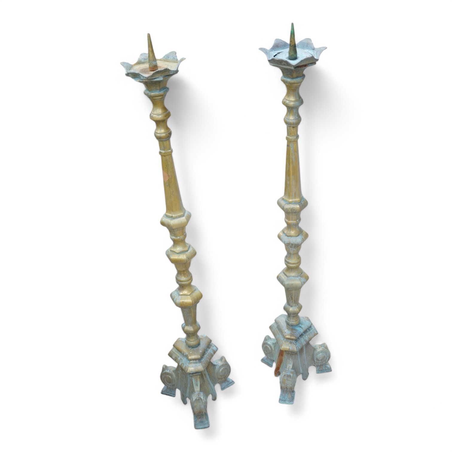 A pair of brass floor standing pricket candlesticks, 110cm high. Condition - both have verdigris and one top plate is cracked.